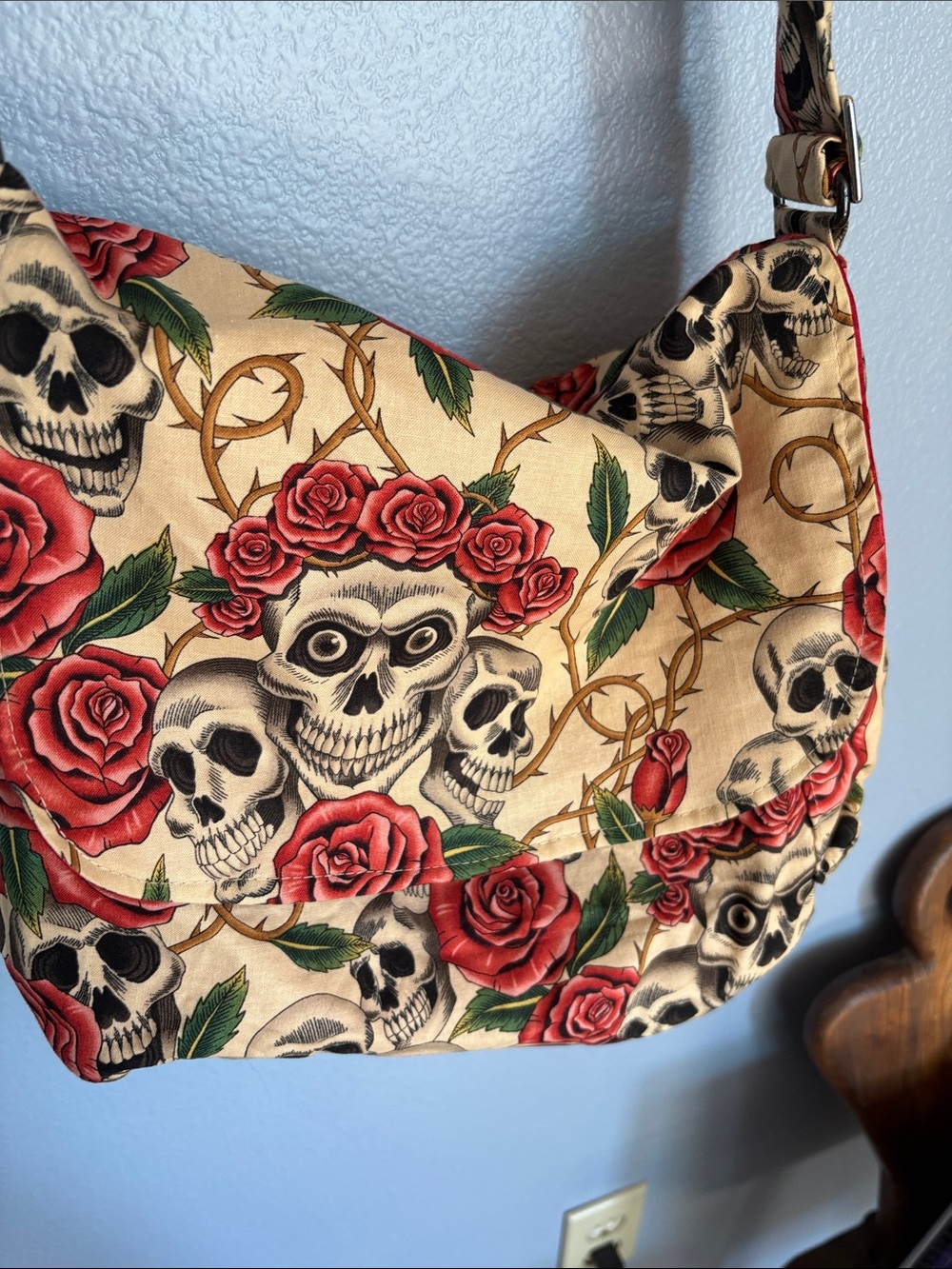 HEMET Skull with Roses print messenger bag. Adjustable strap.red satin lining.